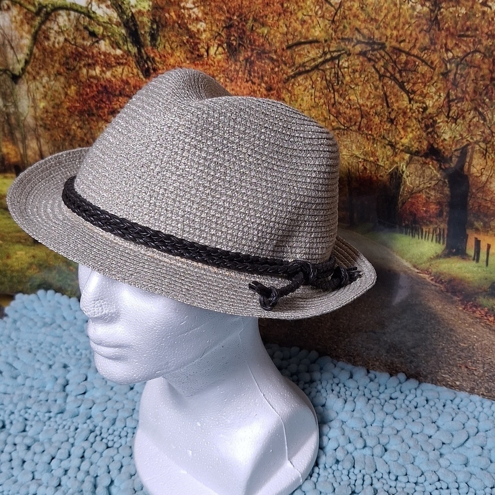 Woman's gold metallic hat with decorative rope.